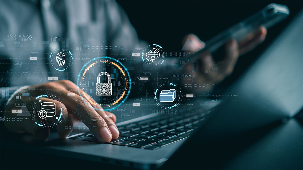 close-up-of-male-hand-pressing-keys-on-laptop-keyboard-while-digital-icons-of-cybersecurity-hover-over-them